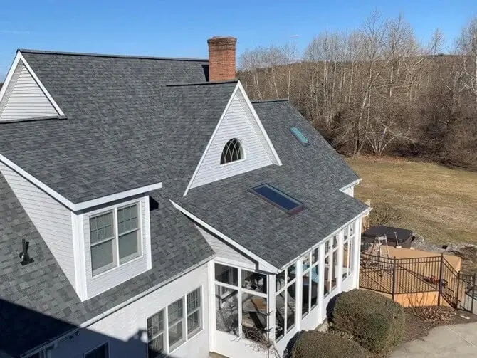 Aerial view of a completed roof replacement on a Connecticut cape home