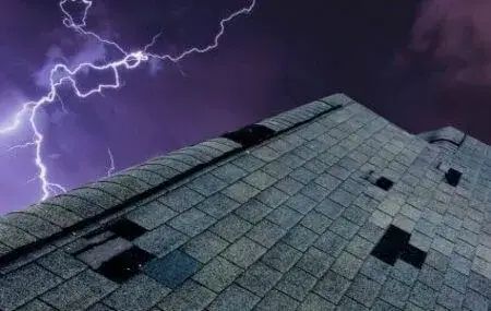 Storm-damaged roof shingles needing repair